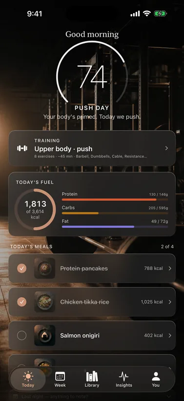 The Basis Today screen: a 74% recovery readout, today’s macros, and the day’s meals over a warm gym scene.